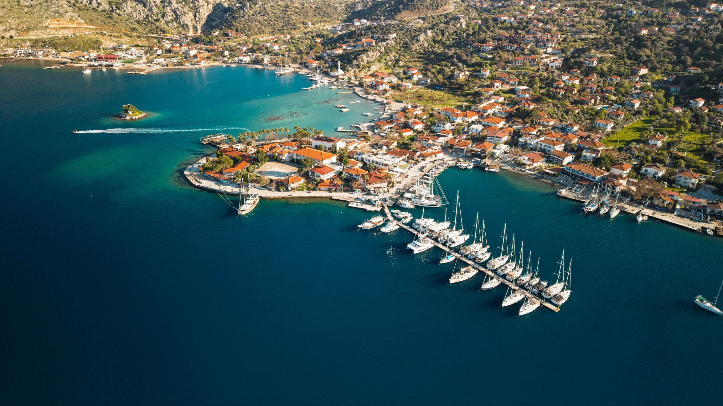 Aerial view of a coastal marina and turquoise shoreline