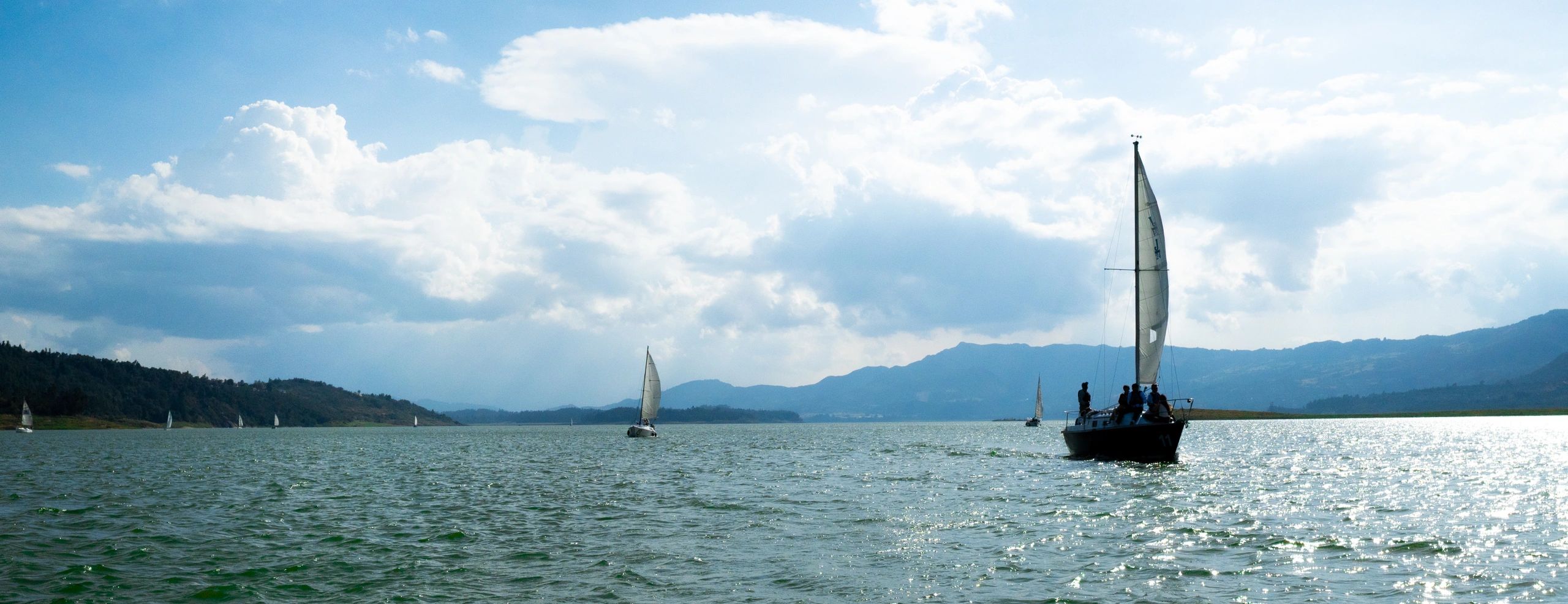 Sailboats on open water at golden hour