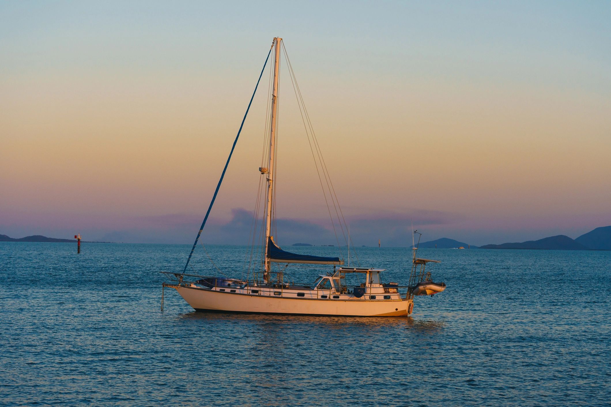 Sailboat on calm water at golden hour